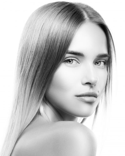Beautiful Healthy Girl beauty portrait. Black and white Close-up beauty model woman face, perfect skin, nude make-up, luxury blonde hairstyle face. White background